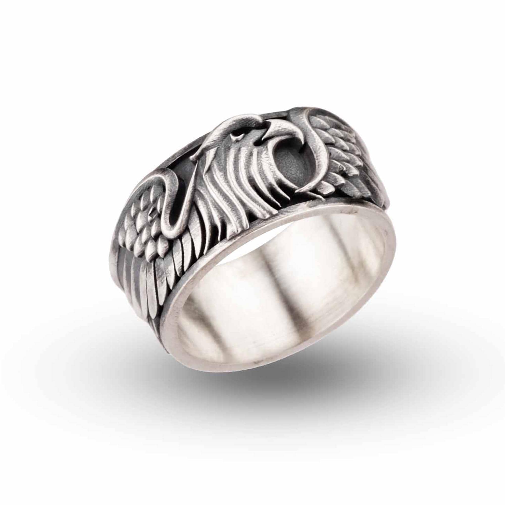 A silver ring with an intricate design featuring a stylized bird or eagle head.