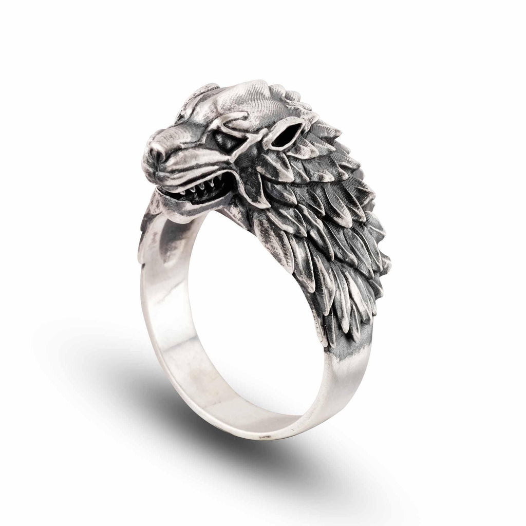 A silver ring with a detailed, sculpted wolf head design.