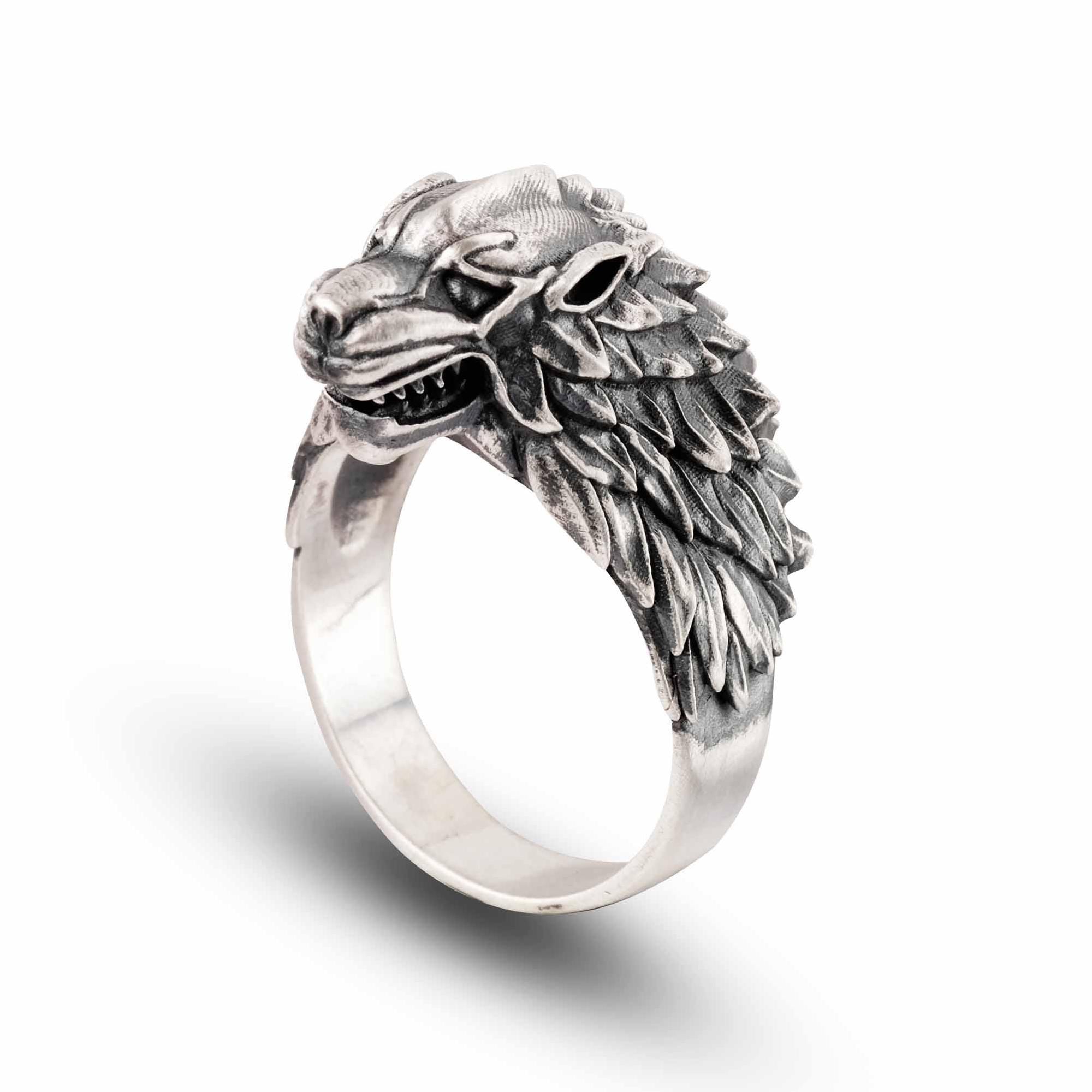 A silver ring with a detailed, sculpted wolf head design.