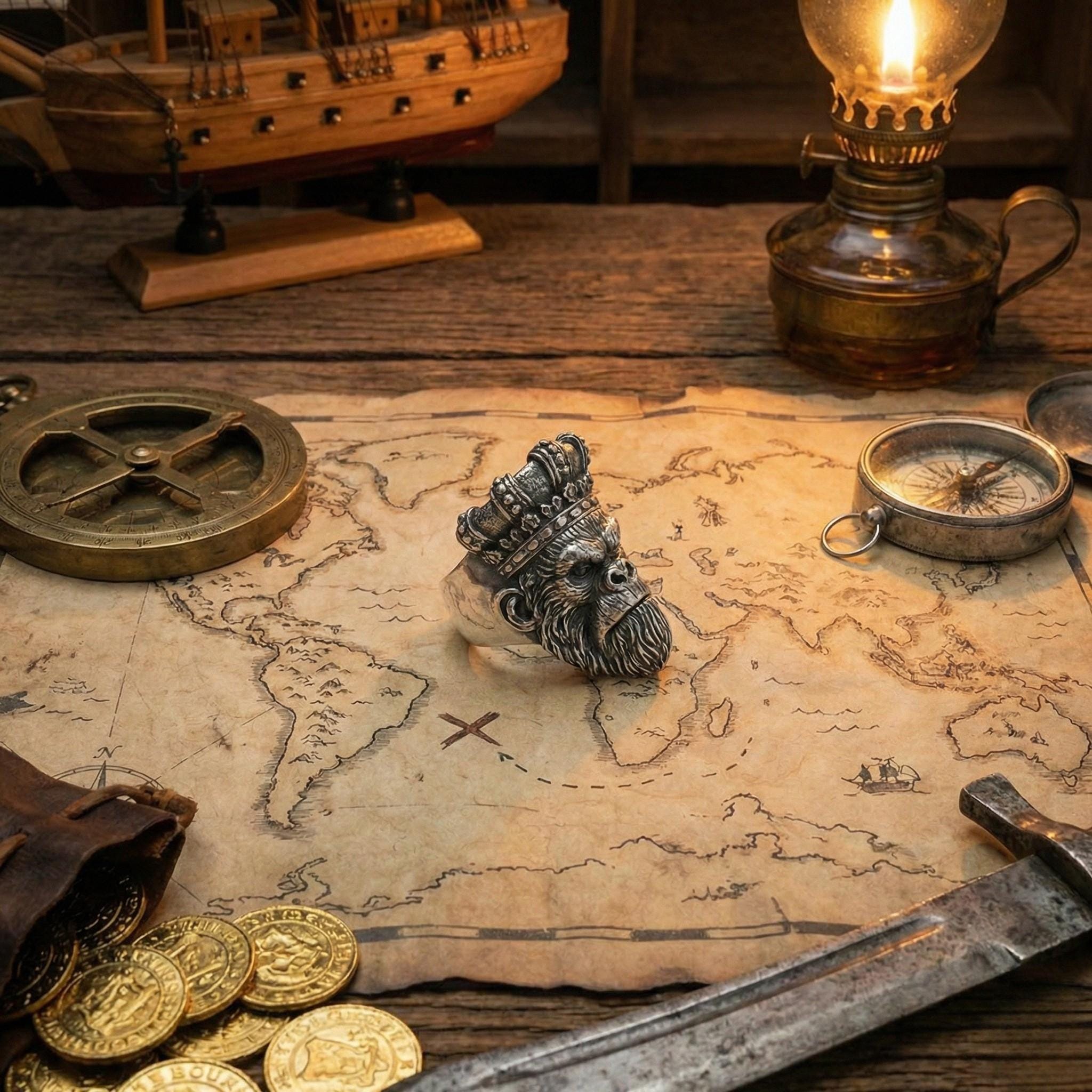 a map with a metal head figure, a lantern, a compass, and various other objects arranged on a wooden surface.