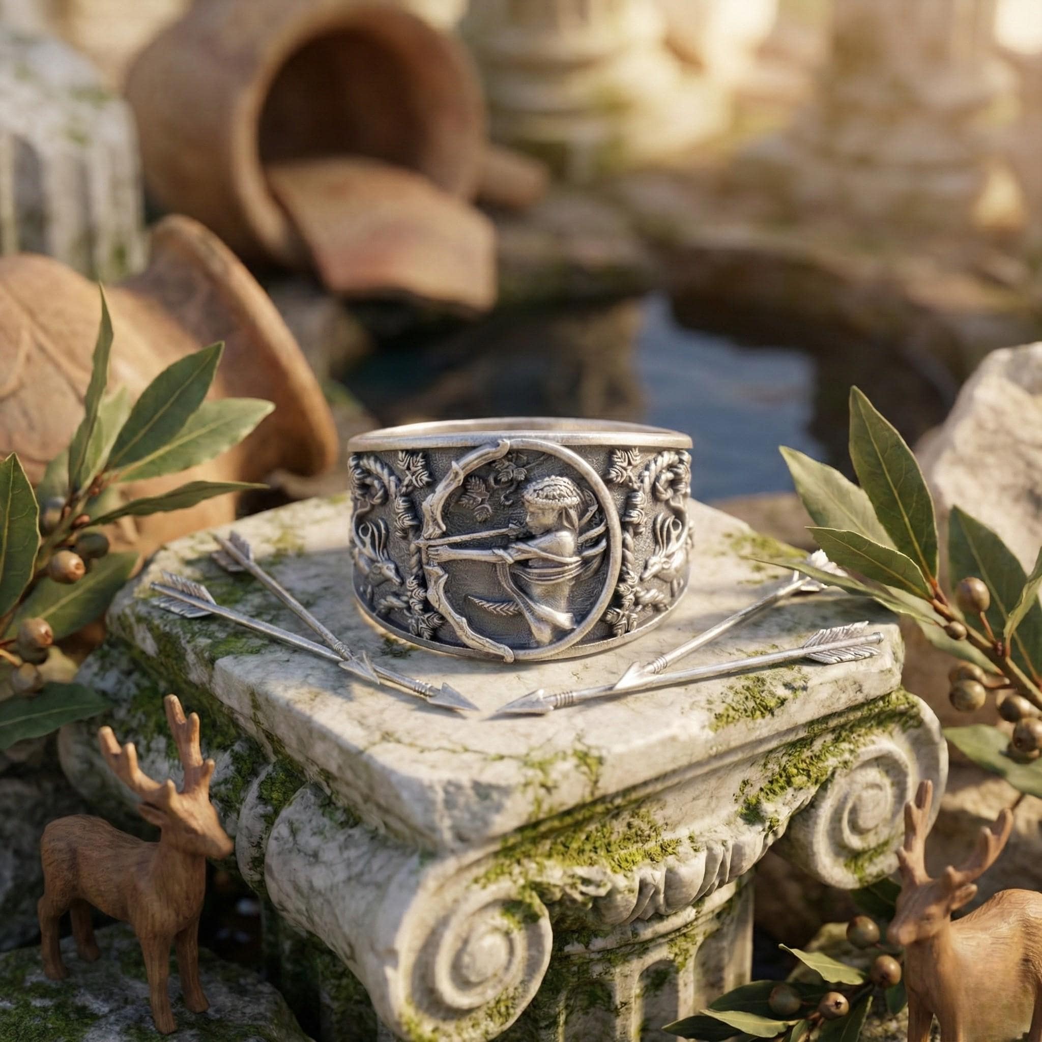 a silver ring with an intricate design, placed on a stone pedestal surrounded by various objects, including a deer figurine and a broken pot.
