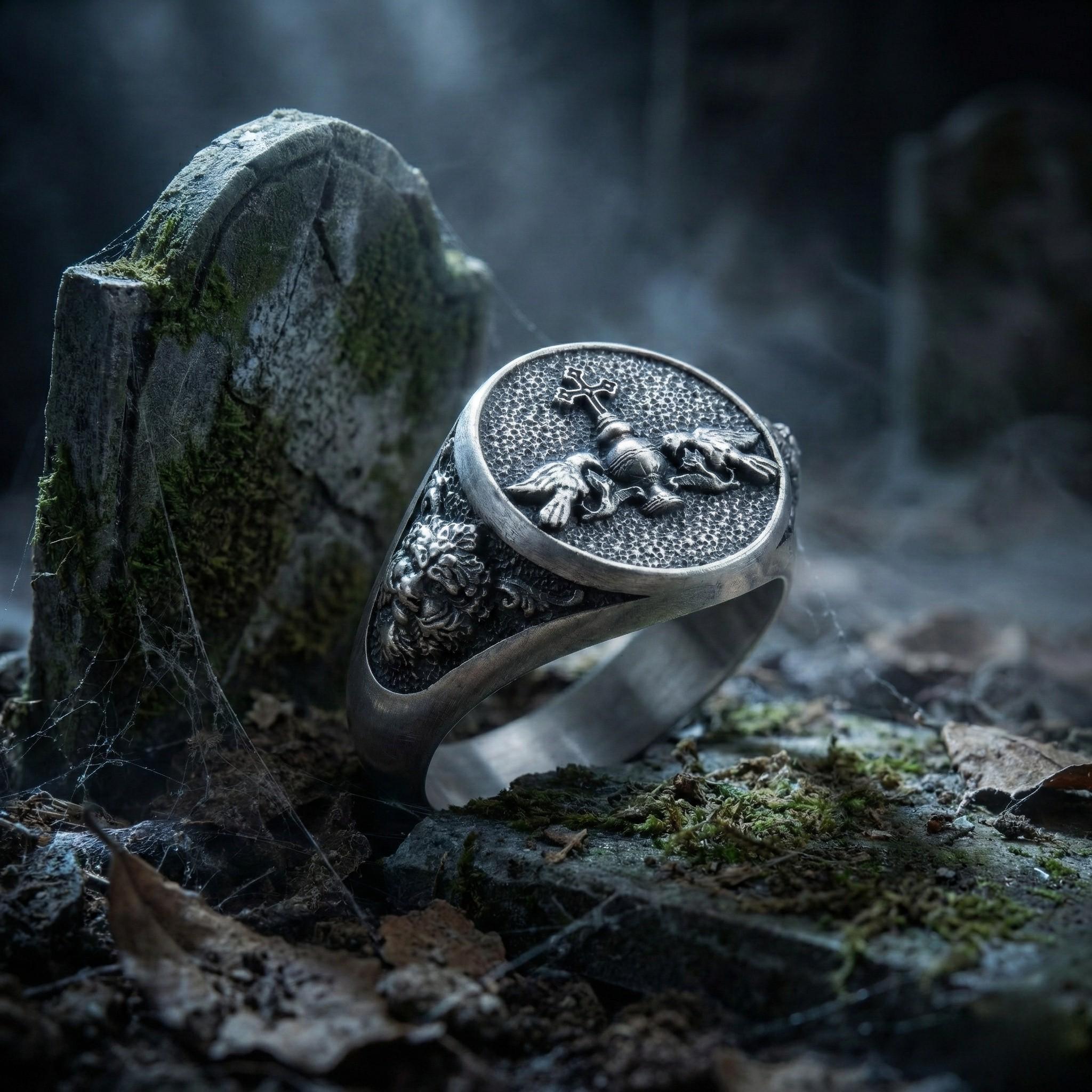 A silver ring with a skull and crossbones design is resting on a mossy rock, surrounded by a dark, mysterious atmosphere.
