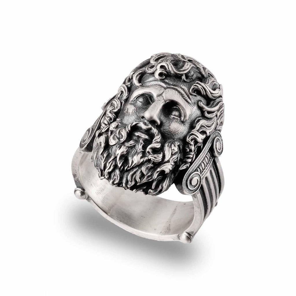 A silver ring with an intricate design featuring a detailed face or sculpture of a bearded man.