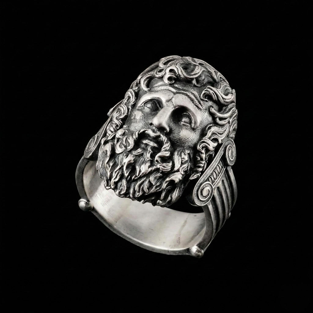 A silver ring with an intricate design depicting a bearded man's face.