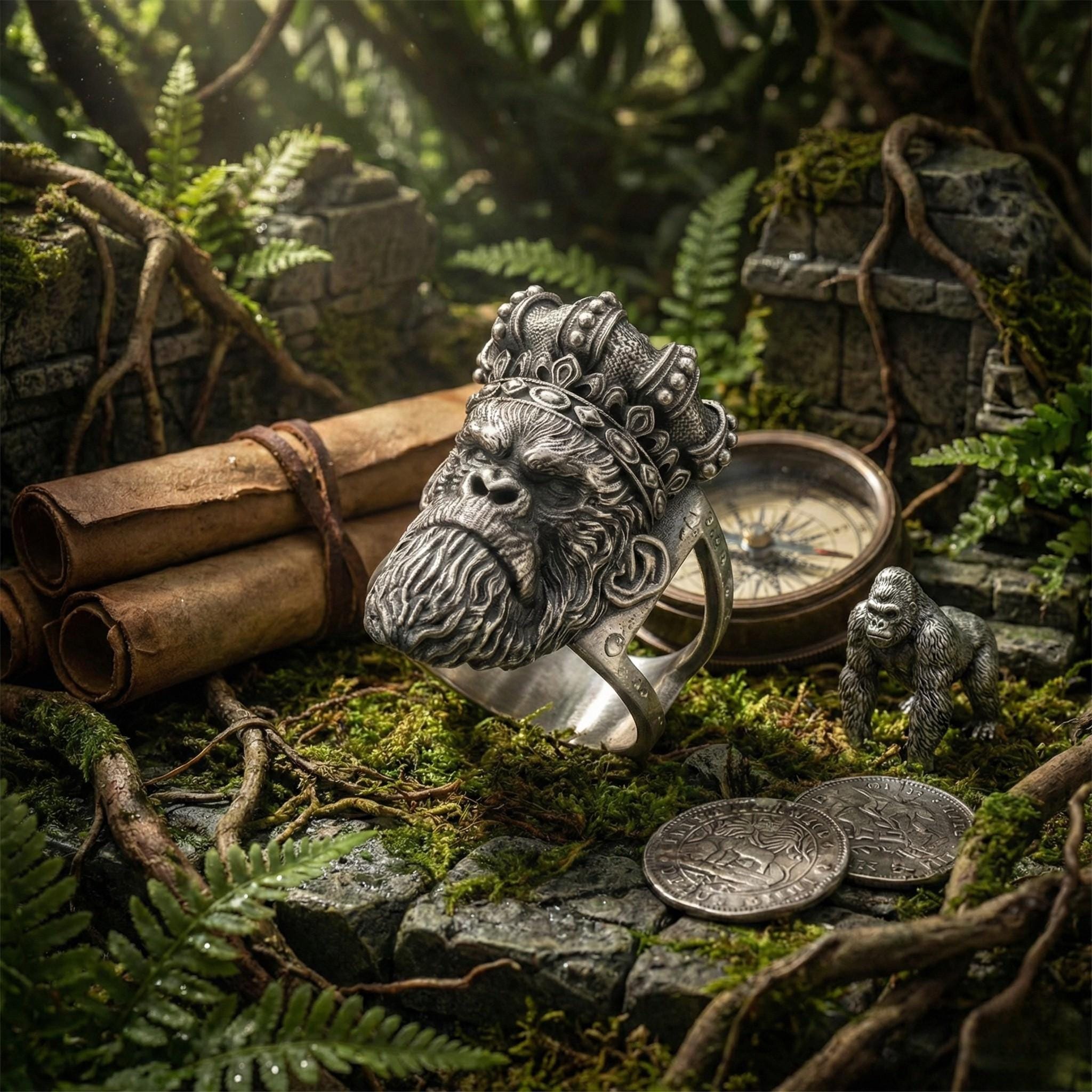 a ring with a monkey head design, surrounded by various objects such as a compass, coins, and a scroll, all set against a lush, green forest backdrop.