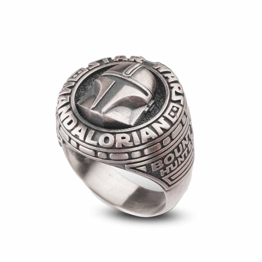 A silver ring with a detailed design featuring a helmet and the text "BOUNTY HUNT" around it.