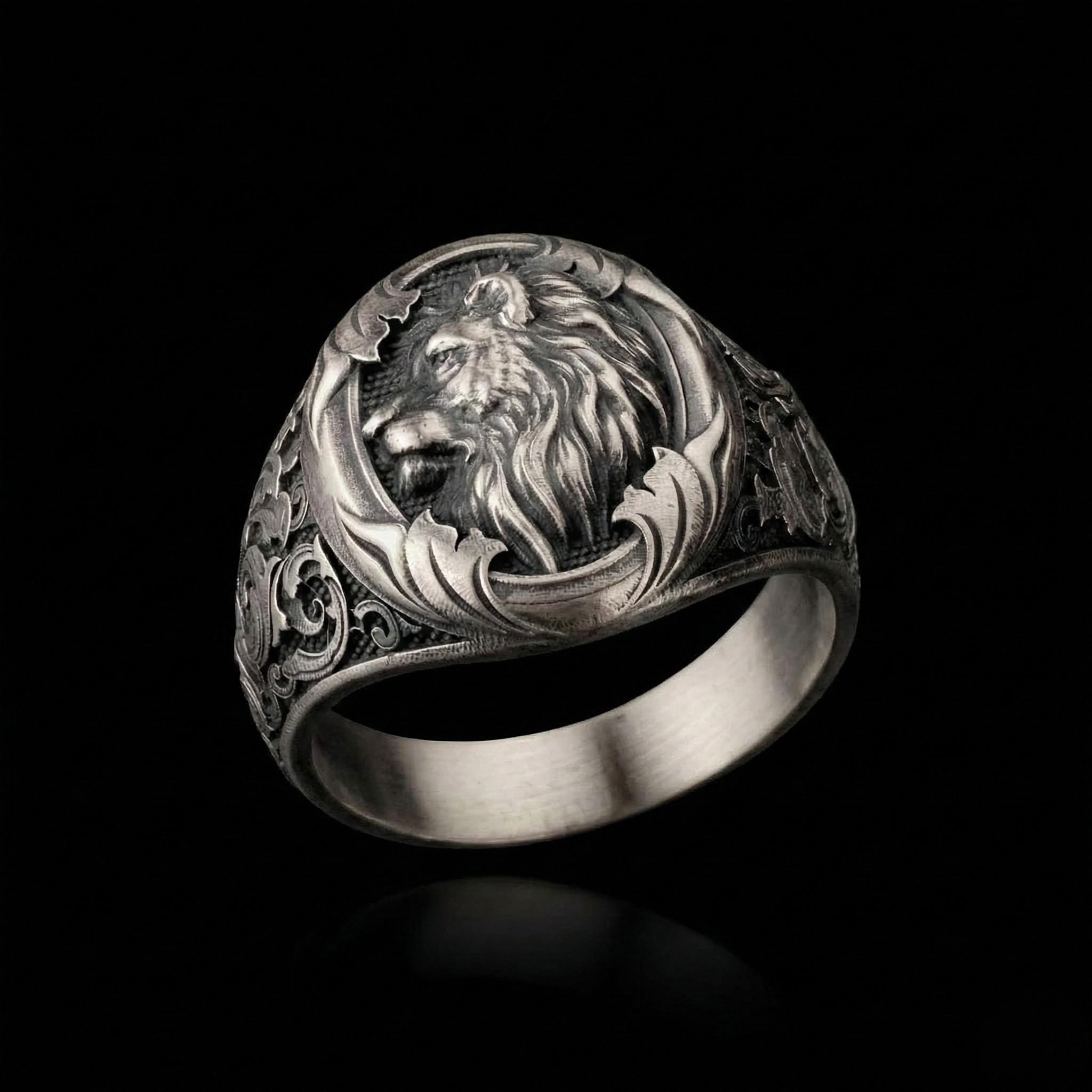 A silver ring with an intricate design featuring a lion's head.
