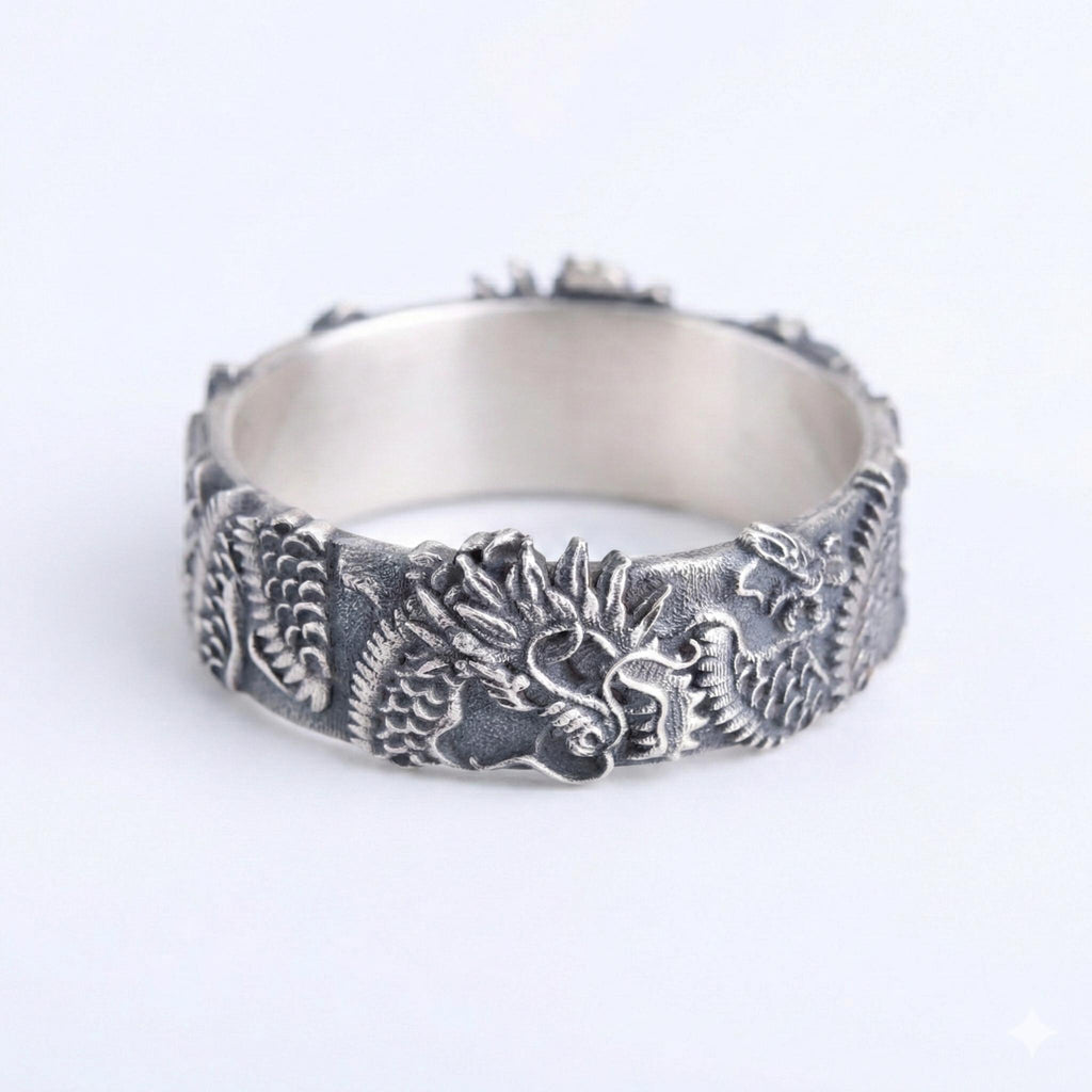 A silver ring with an intricate dragon design on the band.