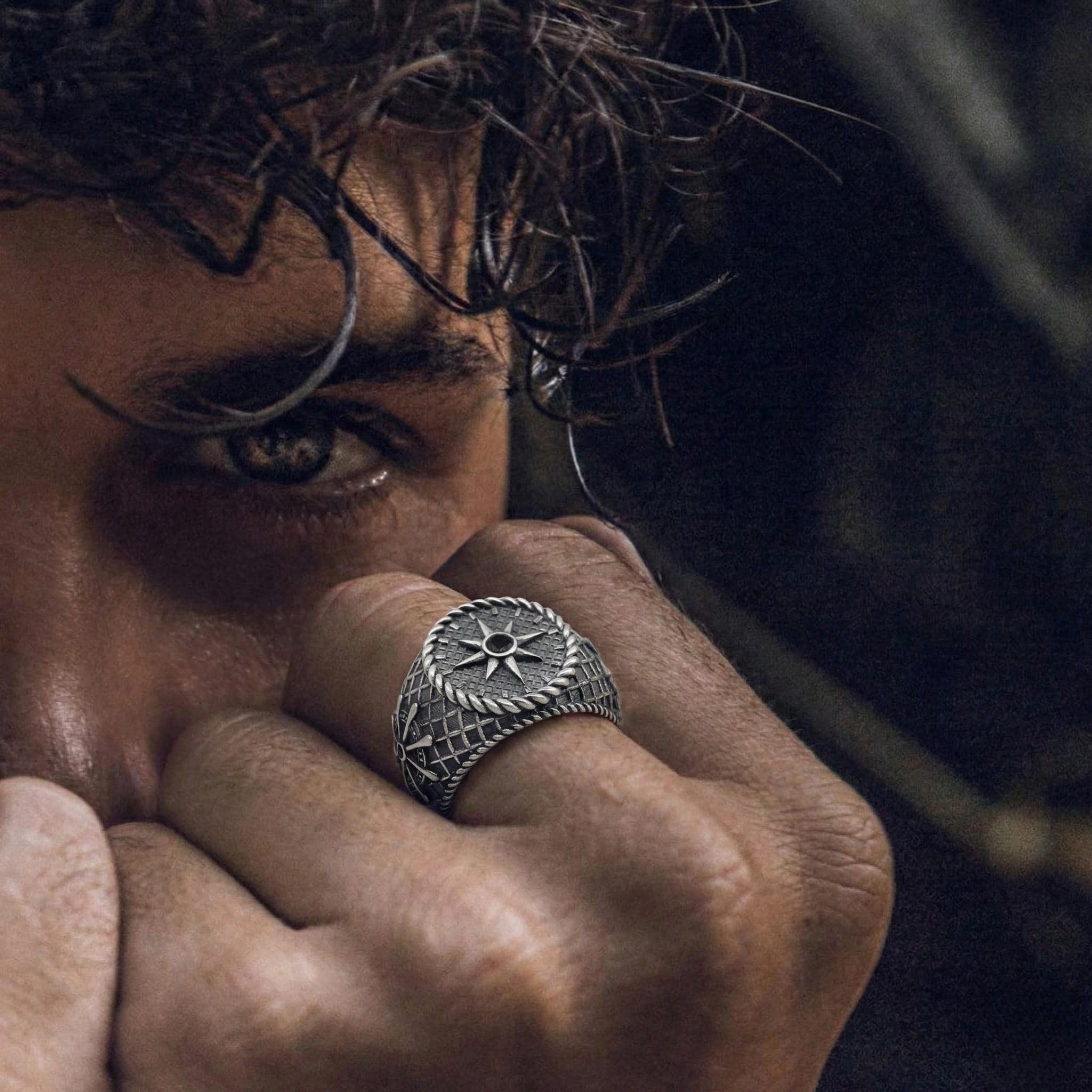 A close-up of a person's face, with their eyes closed and a hand covering their face, partially obscuring their face.