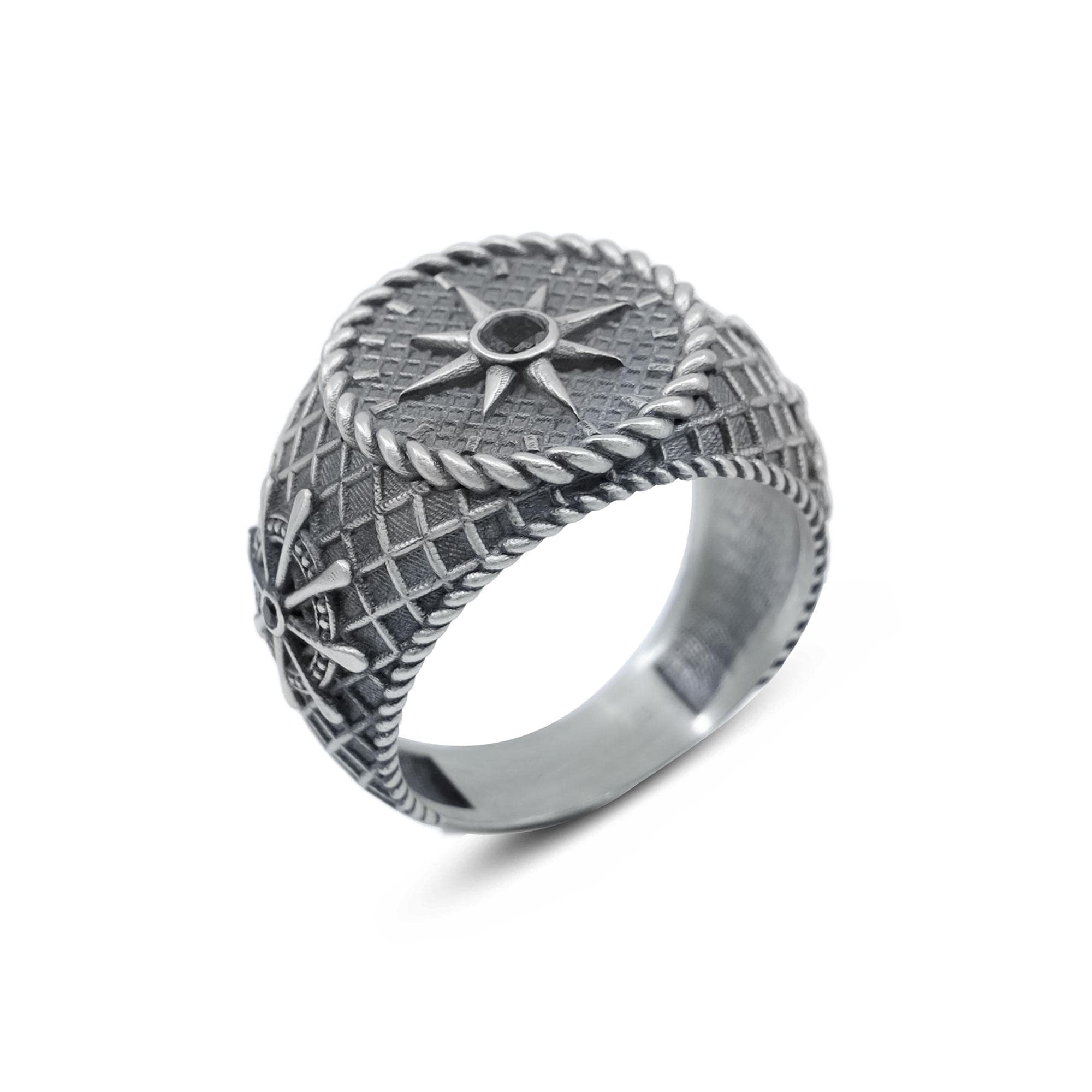 A silver ring with intricate designs and patterns, including a star motif and a rope-like element.