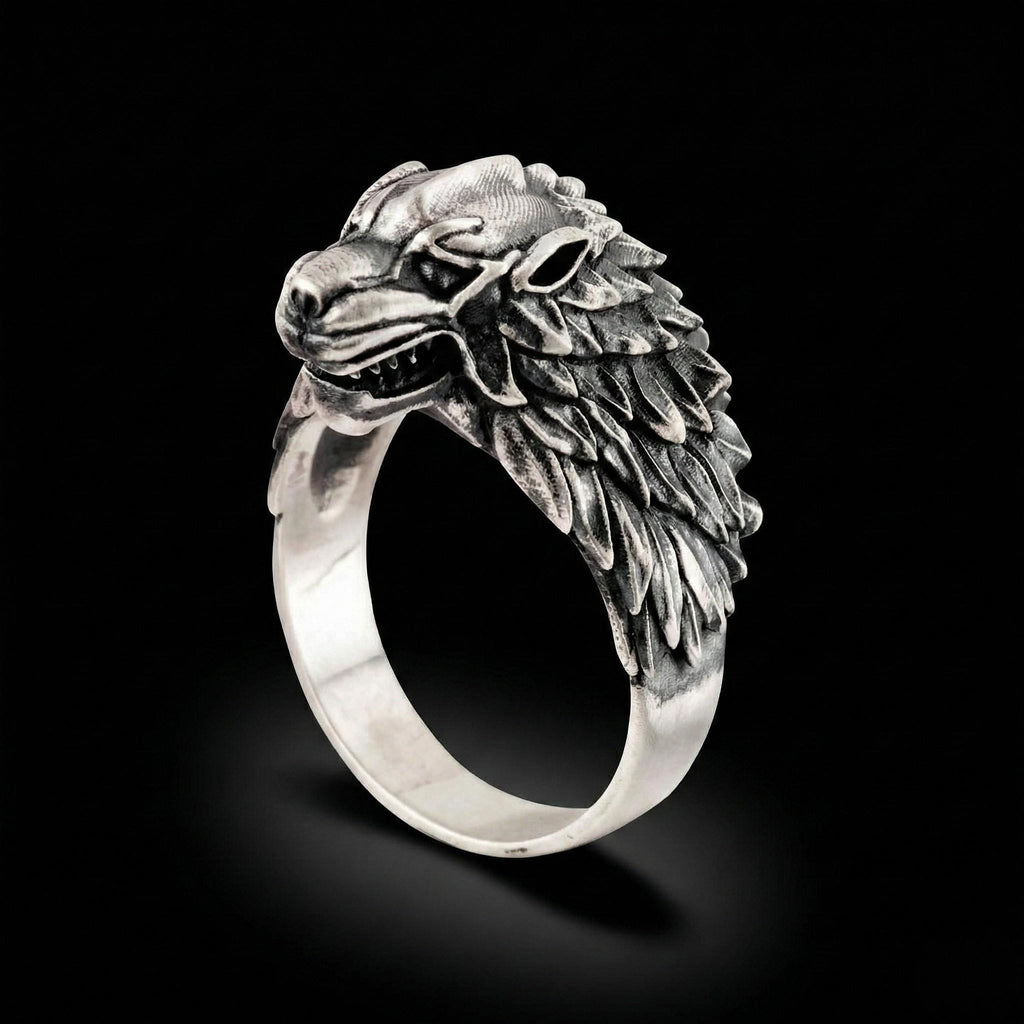 A silver ring with a detailed, sculpted wolf head design.