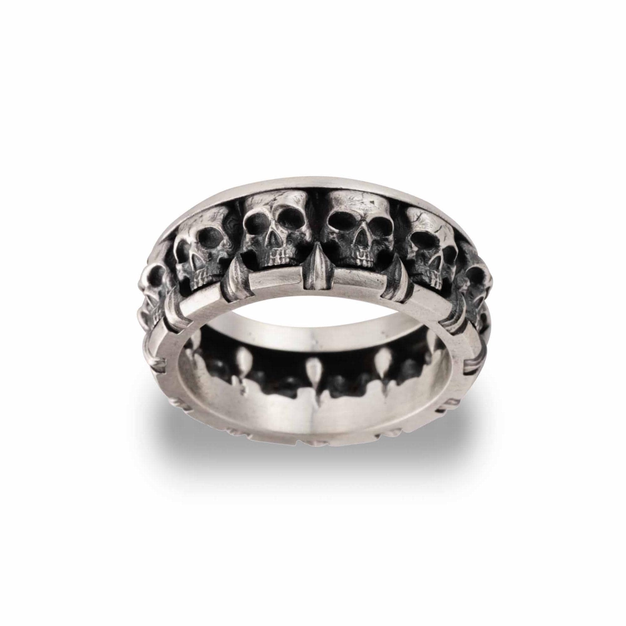 A silver ring with a row of skull designs on the band.
