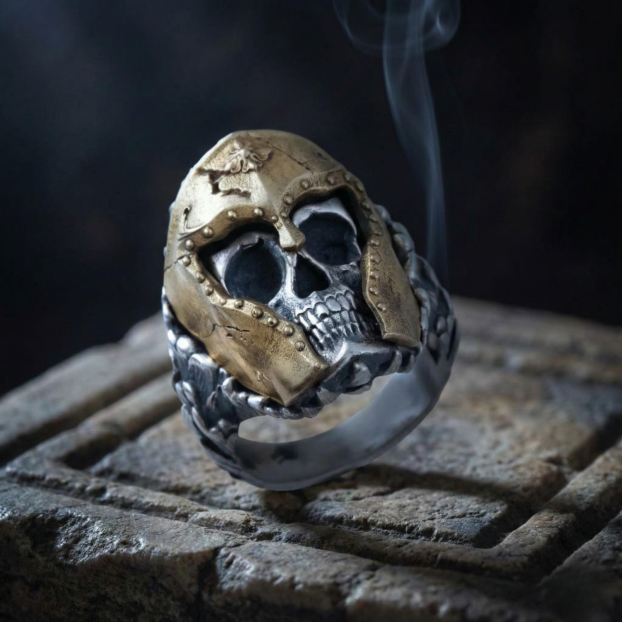 A ring with a skull design on it, with smoke rising from it.