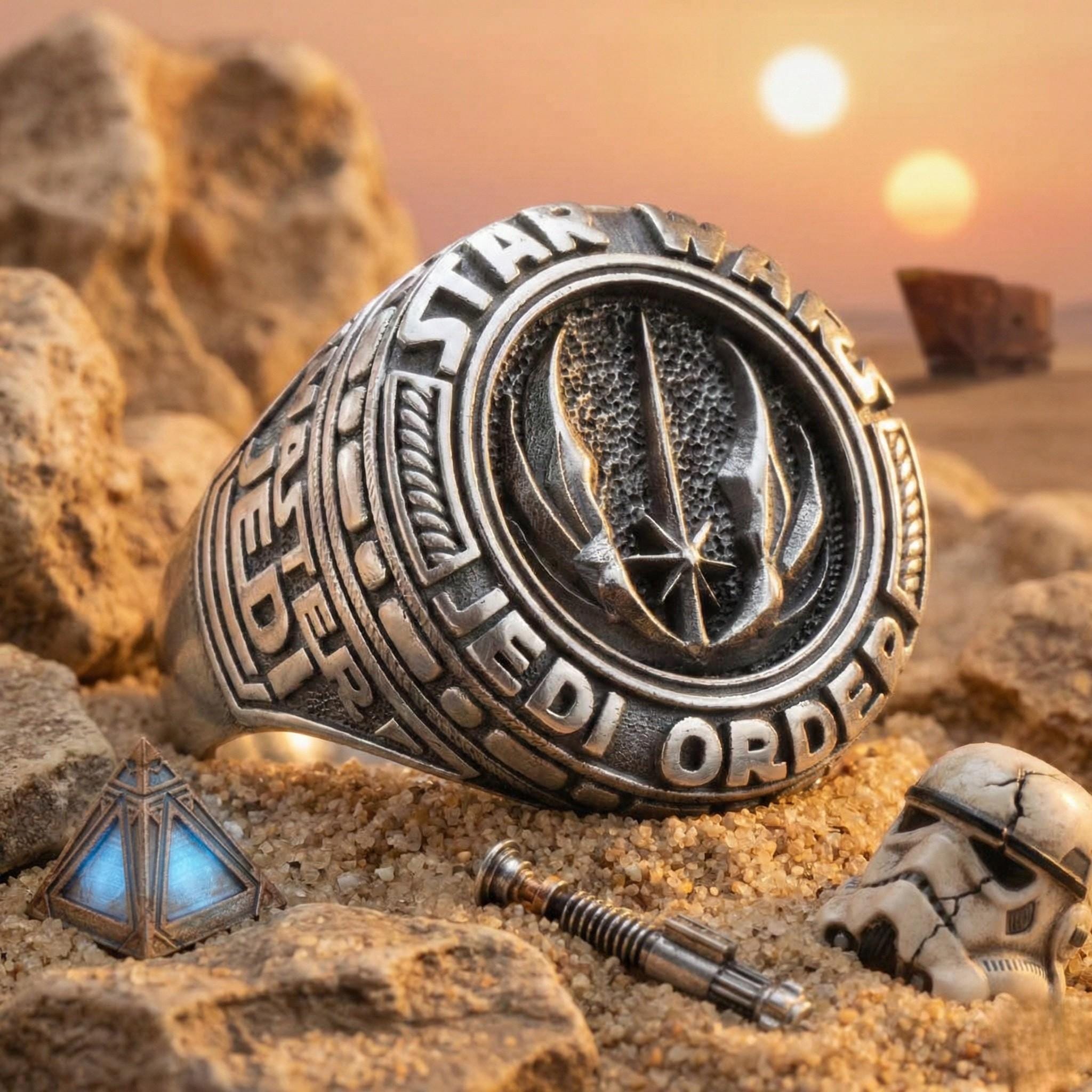a ring with a Star Wars-themed design, surrounded by various Star Wars-related items such as a helmet, a weapon, and a gemstone.