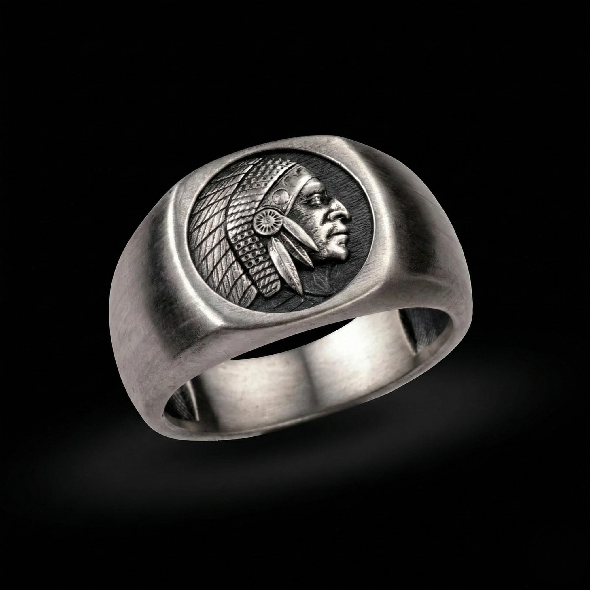 A silver ring with a carved profile of a Native American head on the band.