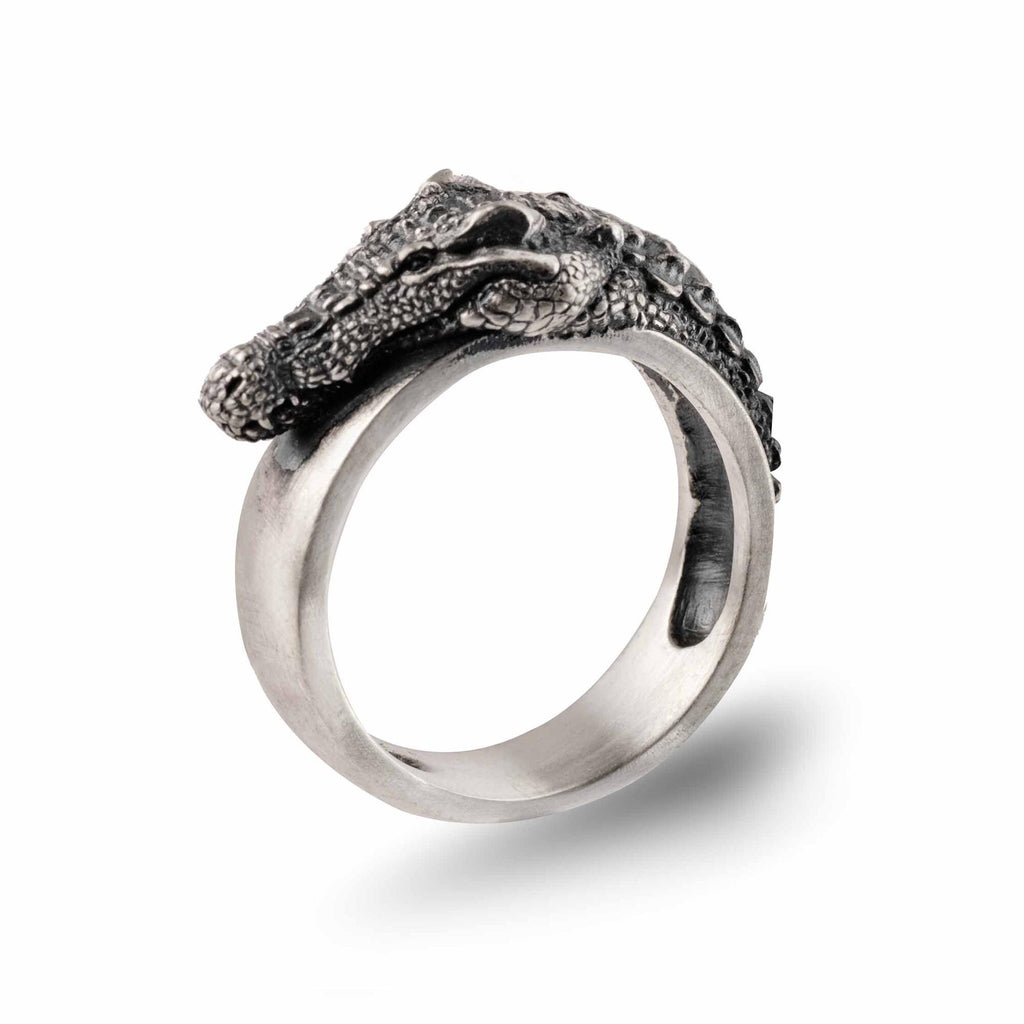 A silver ring with a detailed crocodile head design.