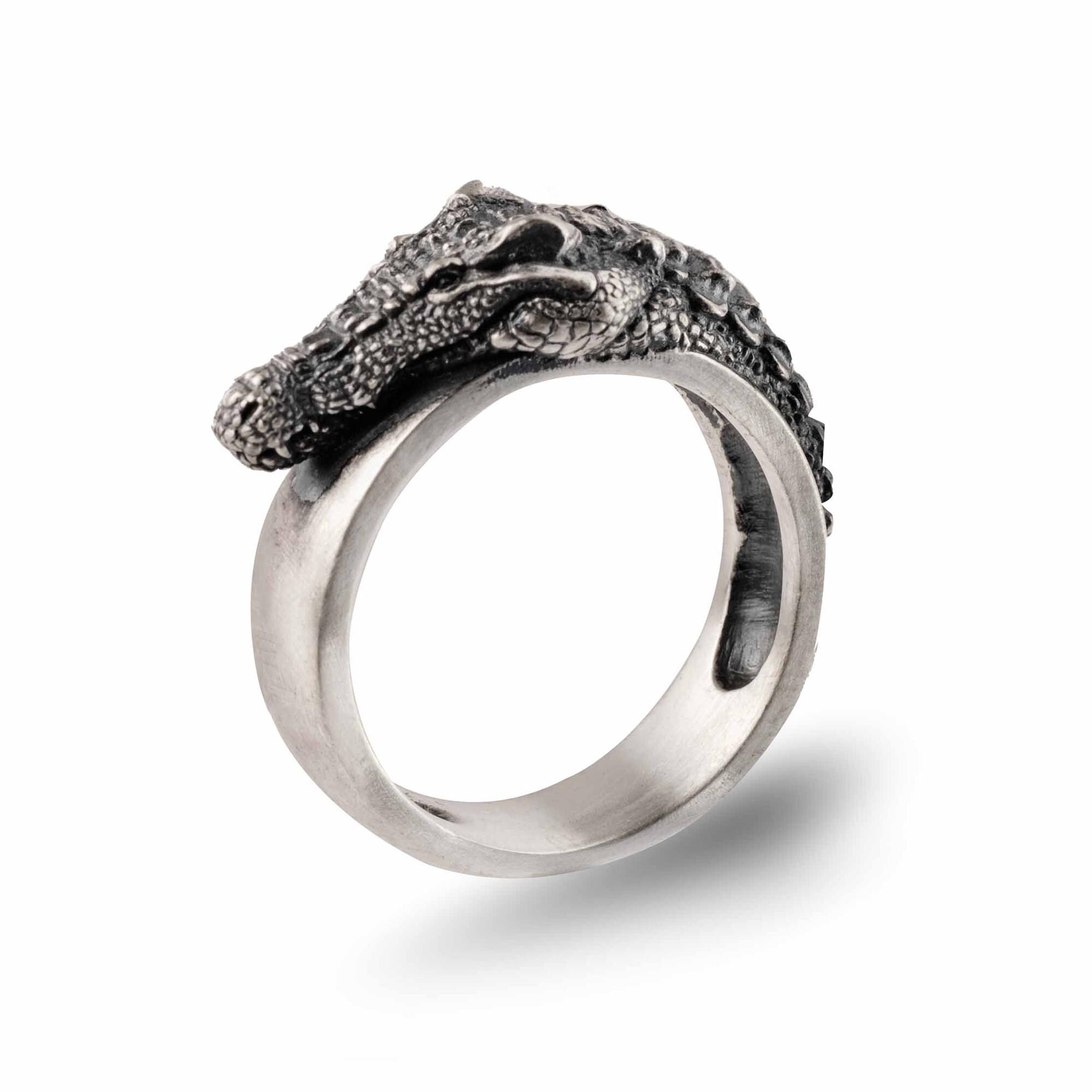 A silver ring with a detailed crocodile head design.