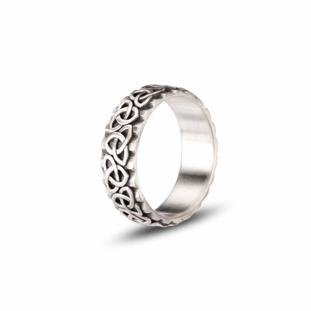 A silver ring with an intricate Celtic knot design.