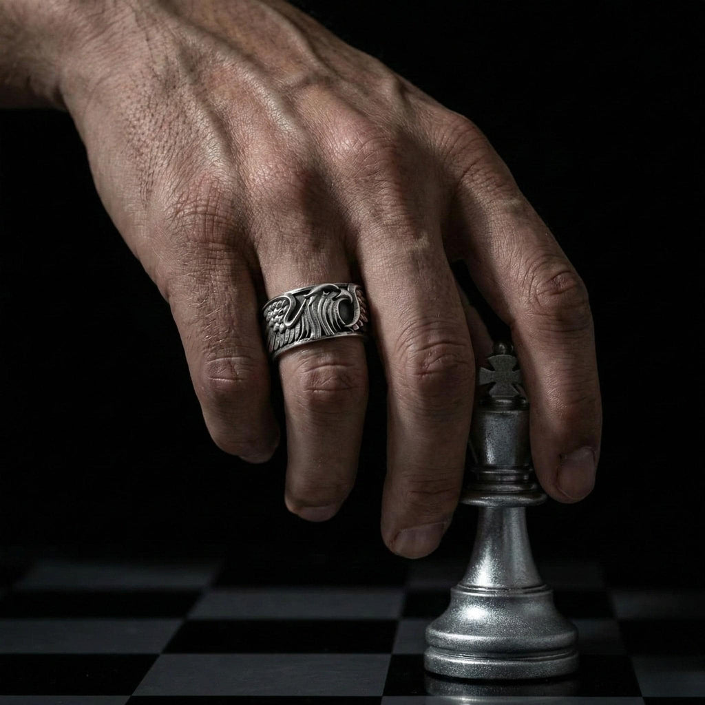 A hand wearing a ring is holding a chess piece, specifically a knight, on a chessboard.