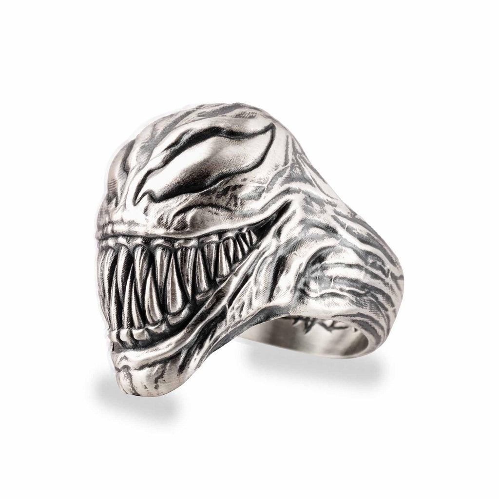 A silver ring in the shape of a menacing, menacing-looking creature with sharp teeth and an intimidating expression.